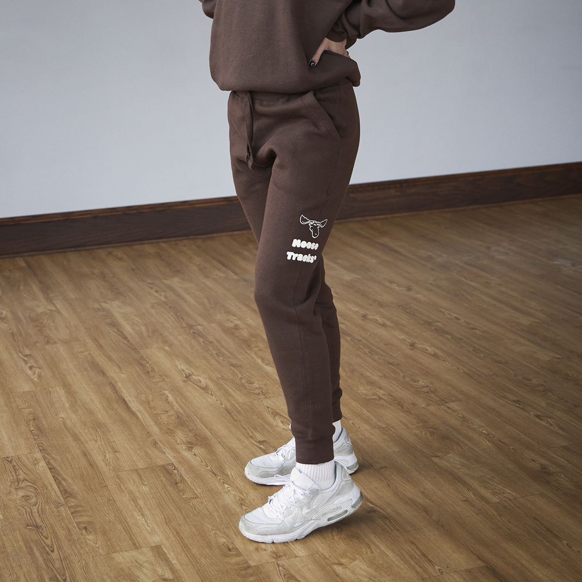 Brown sweatpants with a moose icon and "Moose Tracks" written in vanilla-colored screen printing