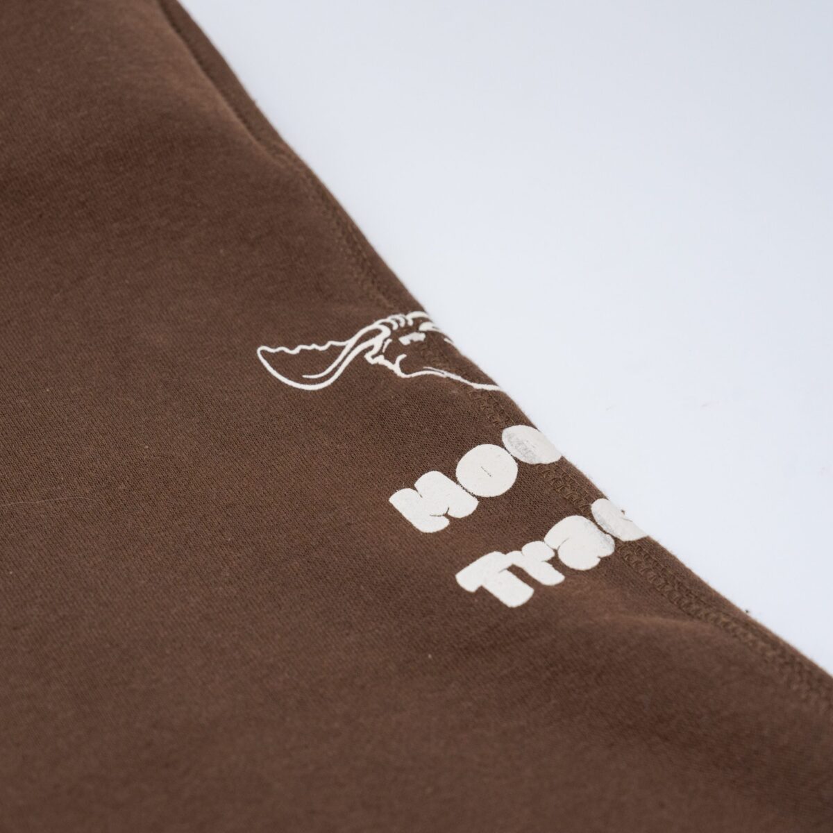 Brown sweatpants with a moose icon and "Moose Tracks" written in vanilla-colored screen printing